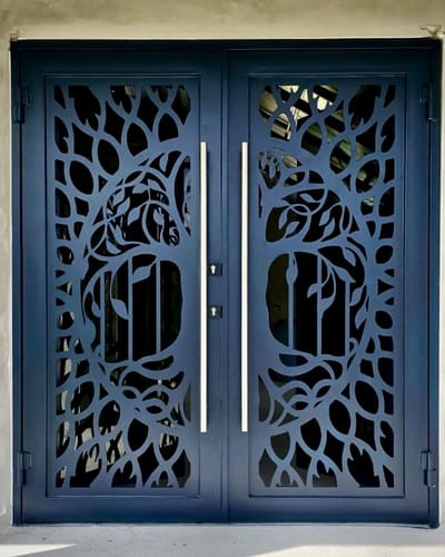 Double entrance doors with a tree and horse cut through the steel