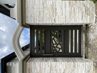 Geometric panel in stone. Pedestrian Gates by Nair Smart Solutions